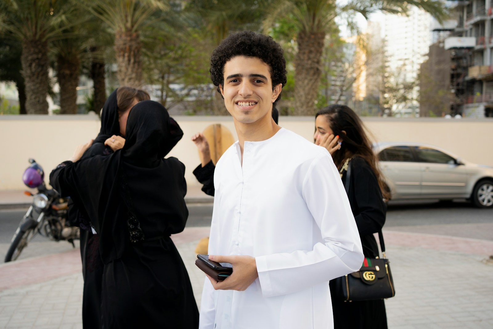 a man in a white outfit standing next to a woman
